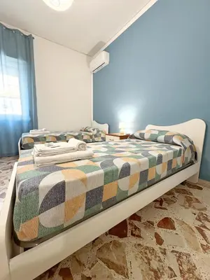 a bedroom with a bed with a plaid blanket at Casa Indipendenza - Cattedrale in Palermo