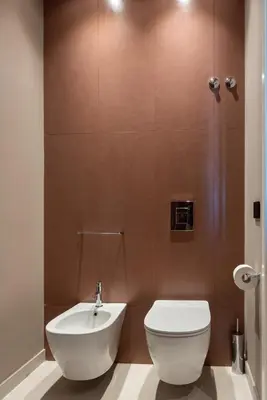 a bathroom with a white toilet and a shower at Limen Wellness Hotel & Spa in Campofelice di Roccella