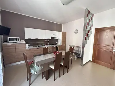 a kitchen and dining room with a table and chairs at Marconi e Garibaldi 76 apartment in Castellammare del Golfo