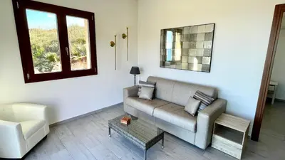 a living room with a couch and a chair at Villa Felice - SEAVIEWS & PRIVATE POOL in Scopello