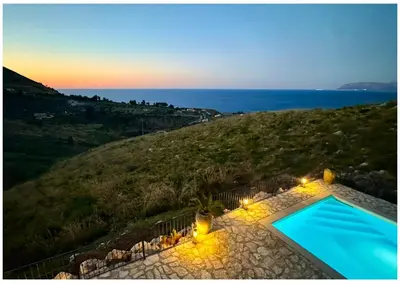 a villa with a swimming pool on a hill with the ocean at Villa Felice - SEAVIEWS & PRIVATE POOL in Scopello