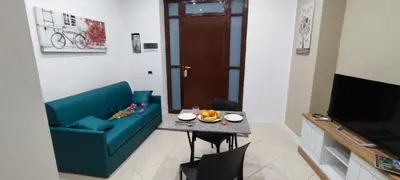 a living room with a blue couch and a table at Leam Apartment 5 in Palermo