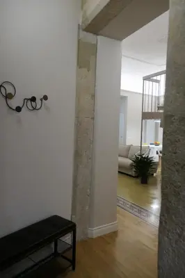 a living room with a white wall and a couch at Opera Suites - Aida in Palermo