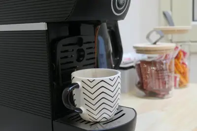 a coffee cup is being brewed in a microwave at Opera Suites - Aida in Palermo