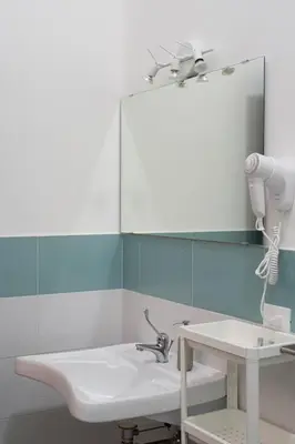 a bathroom with a sink and a mirror at Cortile dei Giusti - Combo Guesthouse in Palermo