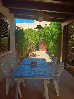 a blue table and chairs on a patio at SanVitoTour- Appartamento Smeraldo in San Vito lo Capo