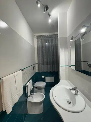 a bathroom with a sink and a toilet at Casa Diamante in San Vito lo Capo
