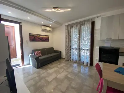 a living room with a couch and a television at Casa Diamante in San Vito lo Capo