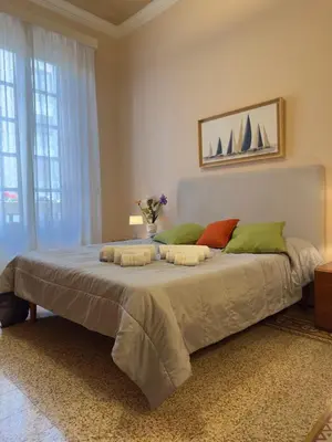 a bedroom with a large bed with green pillows at Appartamento centro in Palermo