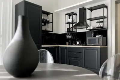 a kitchen with a table with a vase on it at Dimora Borghese “Florio” in Palermo