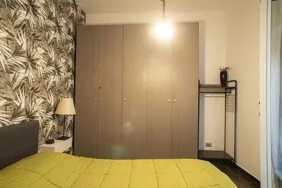 a bedroom with a yellow bed and a wall at 4 Canti Central cozy apt in via Maqueda in Palermo