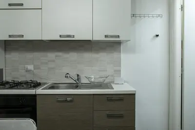 a kitchen with a sink and a stove at 4 Canti Central cozy apt in via Maqueda in Palermo