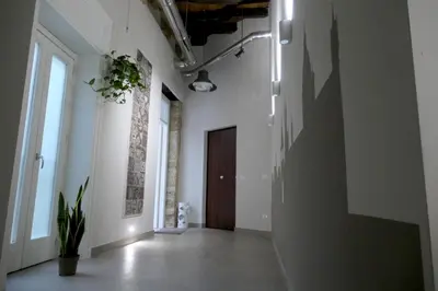 an empty hallway with white walls and a door at Opera Suites - Norma in Palermo