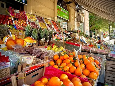 a market with oranges and other fruits and vegetables at 38 HOUSE in Palermo
