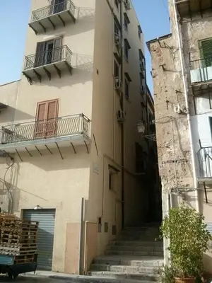 a tall building with stairs leading up to it at A terrace in the heart of Palermo in Palermo