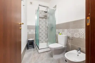 a bathroom with a toilet and a sink and a shower at Mille91 Apartment in Palermo