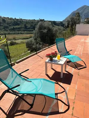 two chairs and a table on a patio at Villa FIORENZA in Castellammare del Golfo