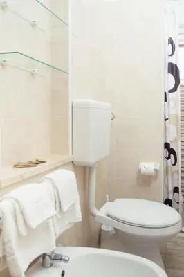 a bathroom with a white toilet and a shower at Meg Sicily House in Castellammare del Golfo