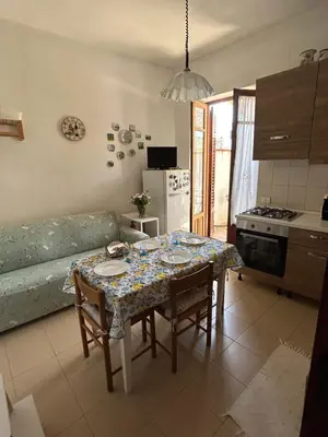 a kitchen with a table with a table cloth on it at Daziarosetta in Palermo