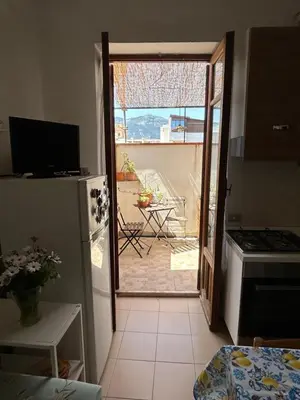 a kitchen with a door open to a patio at Daziarosetta in Palermo