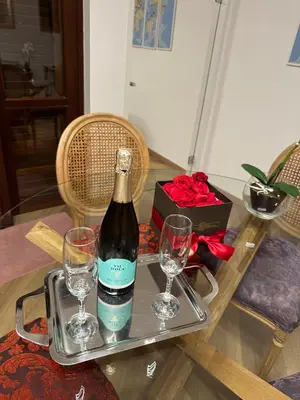 a bottle of wine on a tray with two glasses at Flat with Jacuzzi - Casa Pia in Mondello