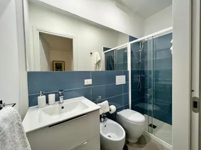 a bathroom with a sink and a toilet and a shower at Case Orlando_a city center Sicilian treat in Palermo