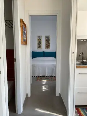 a hallway leading to a bedroom with a bed at Case Orlando_a city center Sicilian treat in Palermo