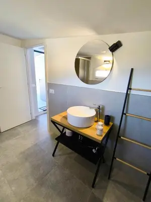a bathroom with a sink and a mirror on the wall at Piante del Principe Apartments in Carini