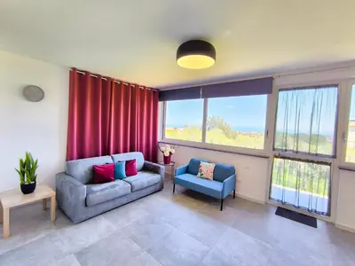 a living room with a couch and a chair at Piante del Principe Apartments in Carini