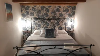 a bedroom with a bed with a black metal headboard at Casa vacanza Gio in Palermo