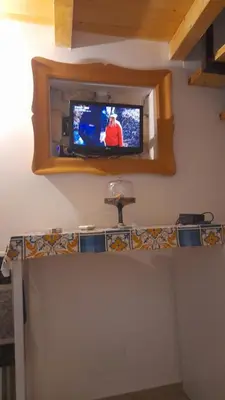 a television on a wall in a room at Casa vacanza Gio in Palermo