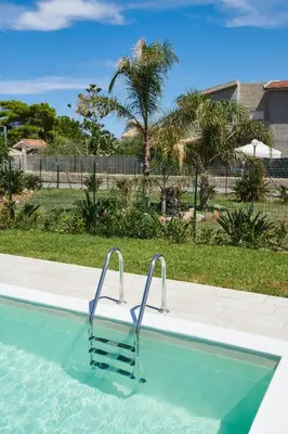 a swimming pool with two handles in the water at Salinelle Rooms in Lascari