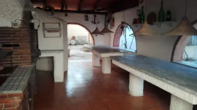 a room with two benches in a building with a fireplace at Villa Mare Ercole Luxury in Trappeto