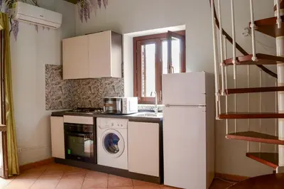 a kitchen with a refrigerator and a washing machine at Happie Casa Il Capo & La Cattedrale in Palermo