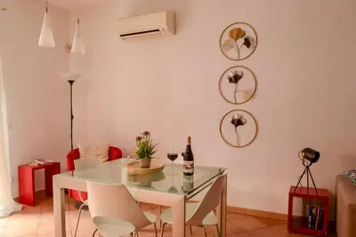 a dining room with a glass table and chairs at Happie Casa Il Capo & La Cattedrale in Palermo