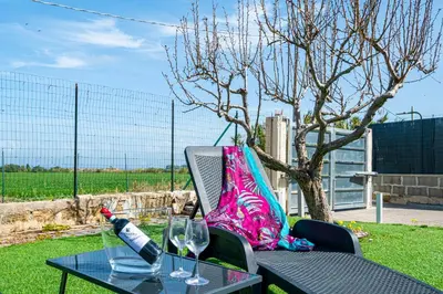 a table with a bottle of wine and a glass at Federica's House - Sporting Village in Scopello