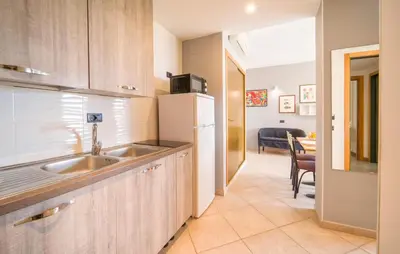 a kitchen with a sink and a refrigerator at Bilo 4 in Lido di Mondello