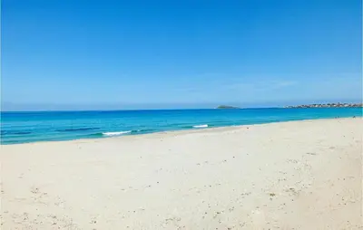 a sandy beach with the ocean in the background at Bilo 4 in Lido di Mondello