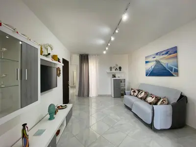 a living room with a couch and a tv at Perla Diva Apartment in Palermo