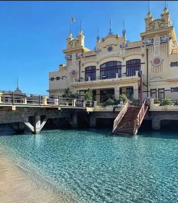 a large building with a bridge over a body of water at Perla Diva Apartment in Palermo