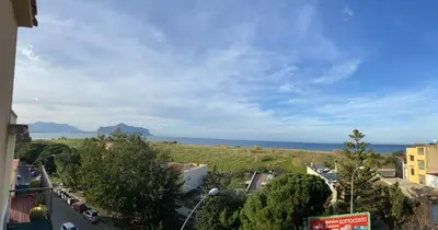 a view of a city with the ocean in the background at Perla Diva Apartment in Palermo