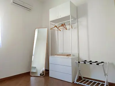 a white refrigerator with a mirror in a room at Appartamento Ai Murales in Palermo