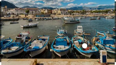 a group of boats are docked in a harbor at Casa Alice in Isola delle Femmine