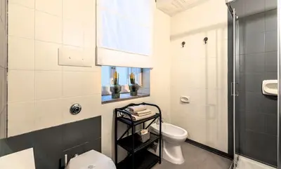 a bathroom with a toilet and a shower at Don Mimì Leisure in Palermo