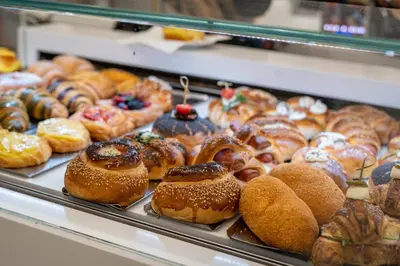 a display case filled with lots of different types of pastries at Don Mimì Leisure in Palermo
