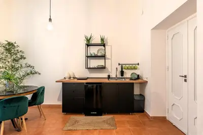 a kitchen with a sink and a table at Don Mimì Leisure in Palermo