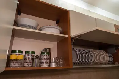 a cupboard with plates and dishes in it at L'isola Che Non C'è in Isola delle Femmine