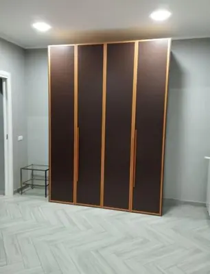 a closet with wooden doors in a room at La casetta dei limoni in Palermo