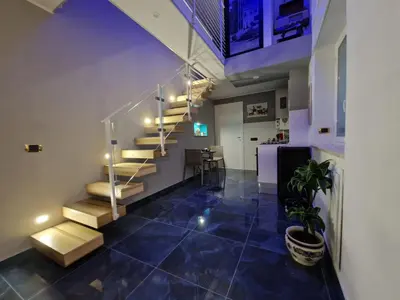 a room with a staircase and a blue tile floor at Confort Home 73 in Palermo