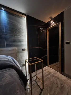 a bedroom with a bed and a table and a closet at Confort Home 73 in Palermo